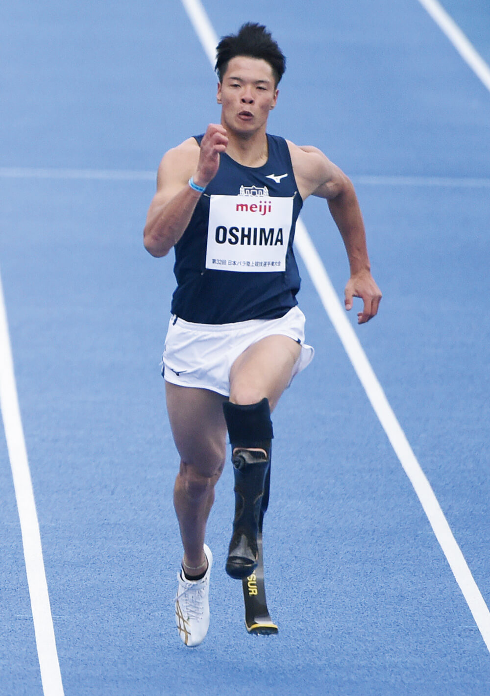 パラ陸上／大島健吾選手が競技場のトラックで走る写真（全身）